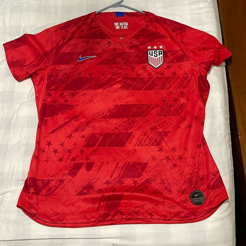 Women’s Nike Dry Fit shirt in bright orange red.